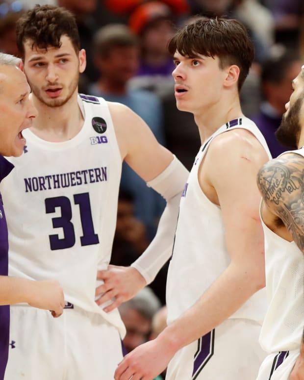 Northwestern basketball coach Chris Collins talks to his players during the Big Ten men’s basketball tournament game against Penn State.